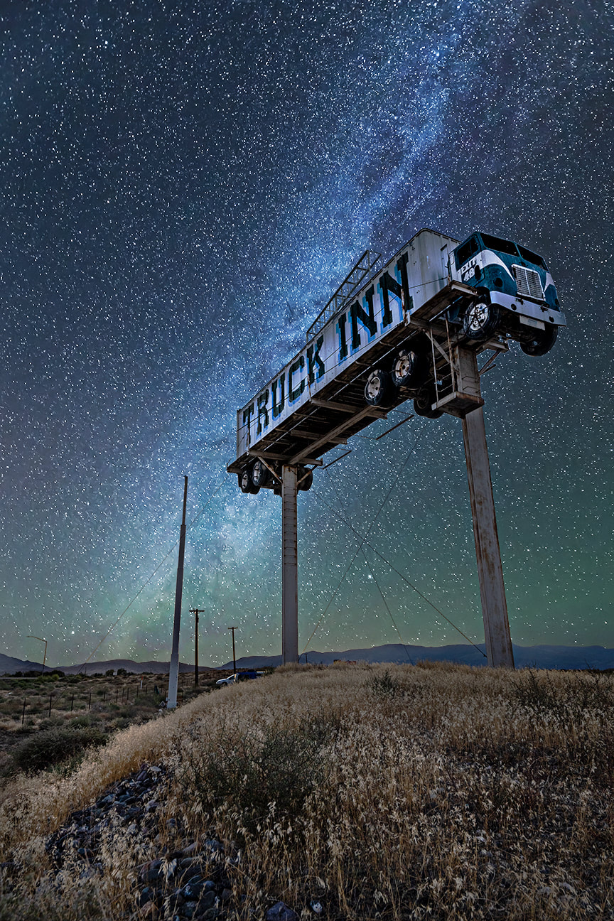 Photograph of Truck Inn located in Fernley, Nevada. Background shows astrophotography, stars, milky way, Reno, Lake Tahoe, desert